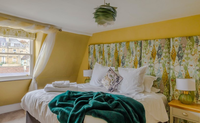 Bright bedroom with yellow and green bedding